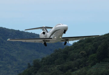 Citation Mustang flying over mountains